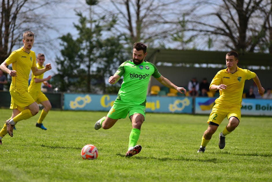 Soccer players engaged in a competitive outdoor match, displaying teamwork and athleticism.
