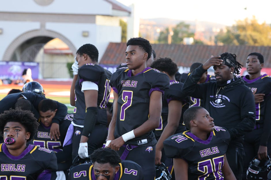 A high school football team preparing before a game, showcasing teamwork and determination.