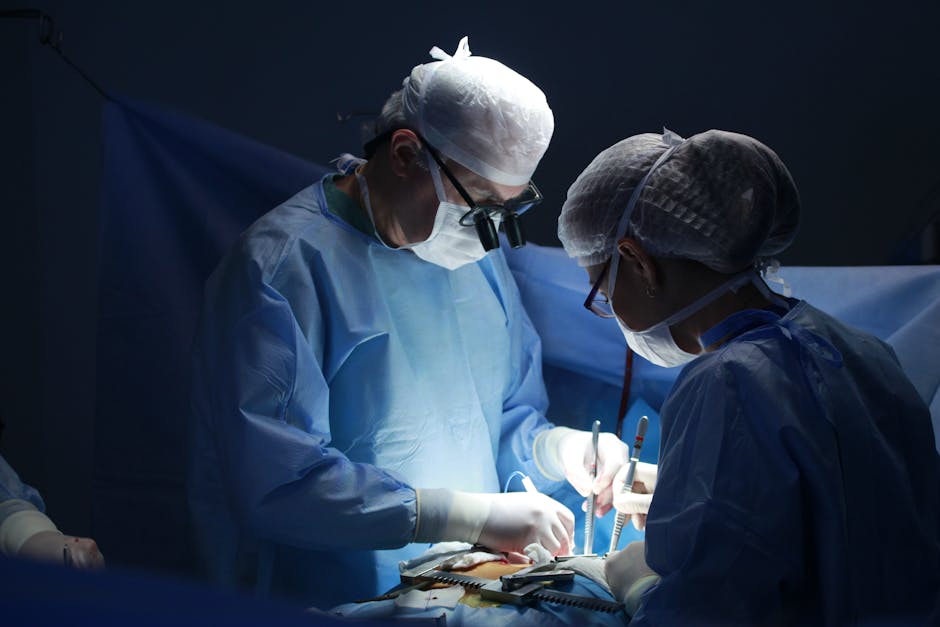 Two surgeons focused on an operation in a well-equipped hospital operating room.