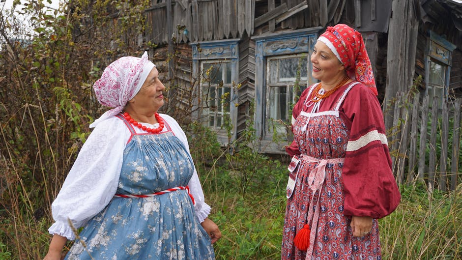 Two women wearing traditional Russian folk costumes outdoors.