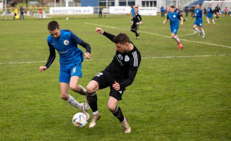 Intense soccer game with players competing for the ball on a grassy field. Strong teamwork and athletic skill displayed.