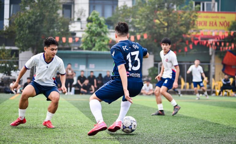 Dynamic soccer game on artificial turf in Hanoi, capturing athleticism and team spirit.