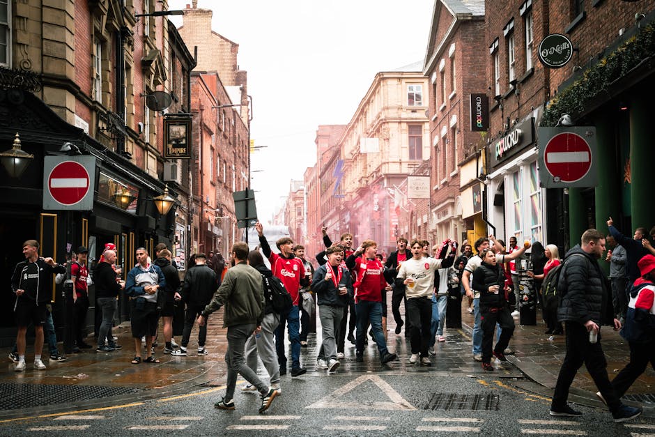 A vibrant street scene of football fans celebrating in Liverpool, England.