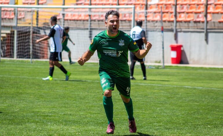 Soccer player in green jersey celebrates a goal during a match on a sunny day.