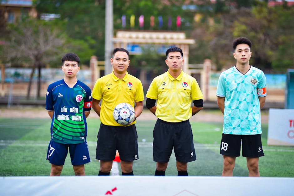 Football players and referees posing before a match in Hanoi, Vietnam.