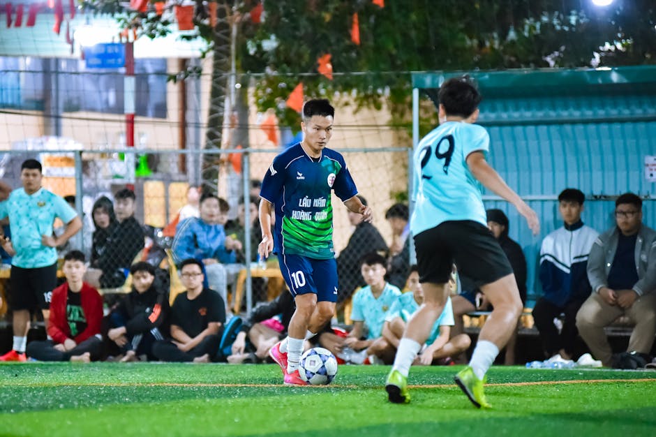Amateur football players in action during a vibrant game in Hà Nội, Vietnam, showcasing sportsmanship and teamwork.
