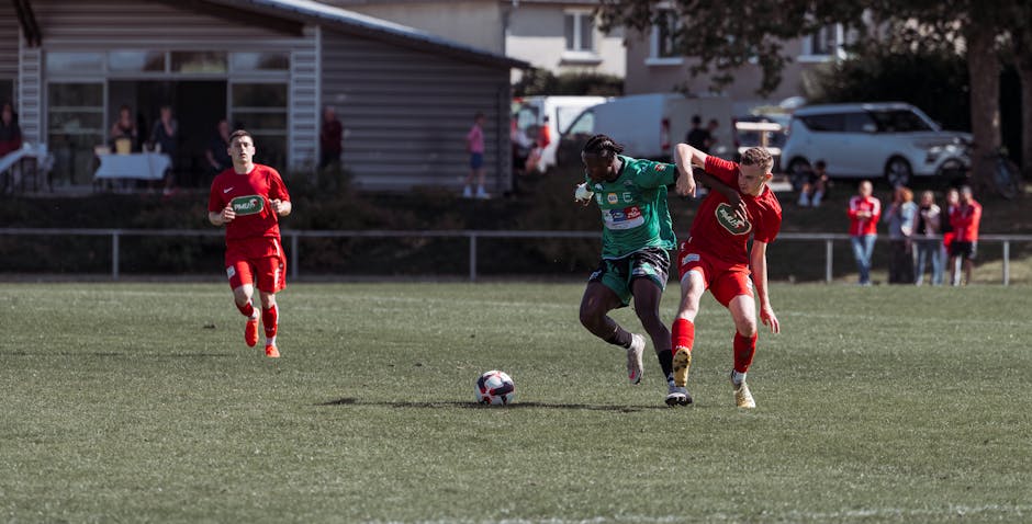 Players in action during an outdoor soccer match on a sunny day in France.