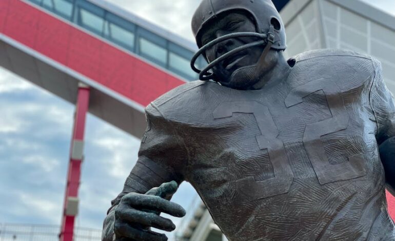Close-up of a football player statue outside a modern stadium in Cleveland, Ohio.