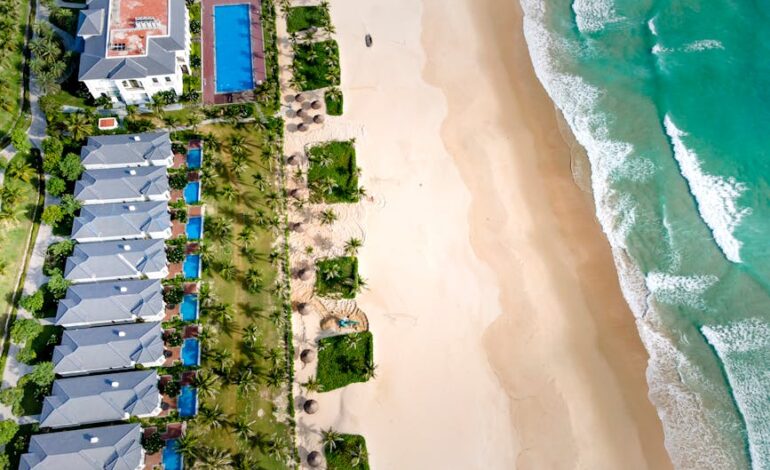 Stunning aerial beach resort view featuring turquoise waters and sandy shores, perfect for tropical getaways.