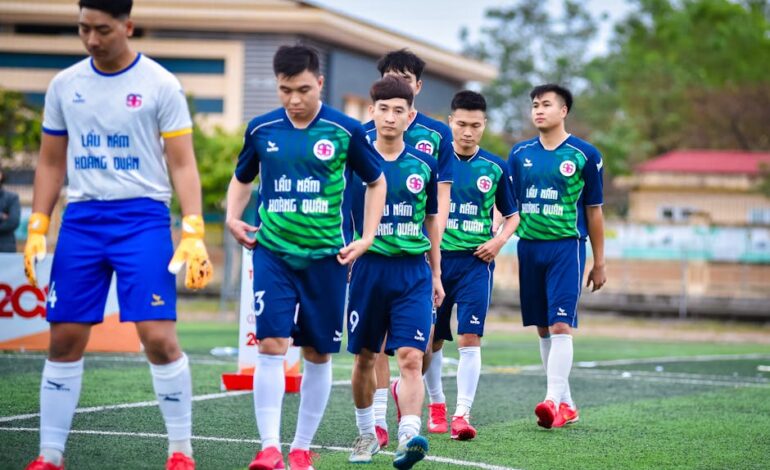 Vietnamese football players walking onto the field in Hanoi.