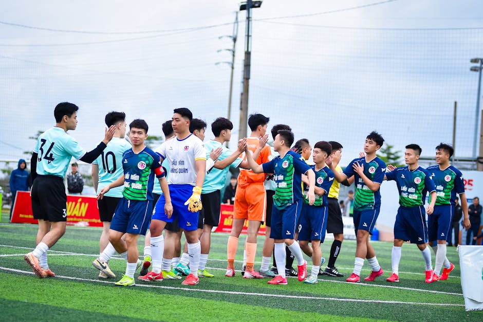 Soccer players from two teams exchange handshakes before a match in Hanoi, Vietnam.