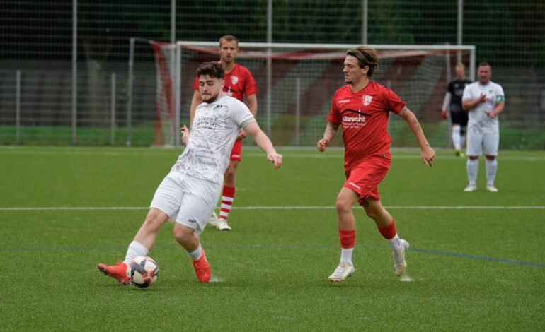 Football players in action during a match on a grassy sports field.