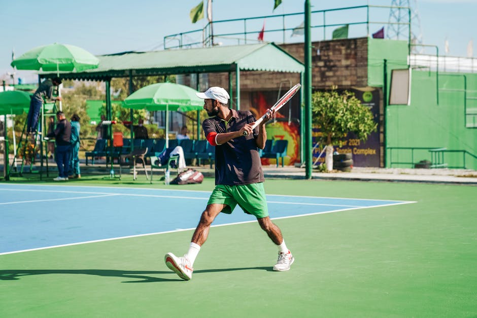Man in action during a tennis match on an outdoor court in Islamabad, Pakistan.