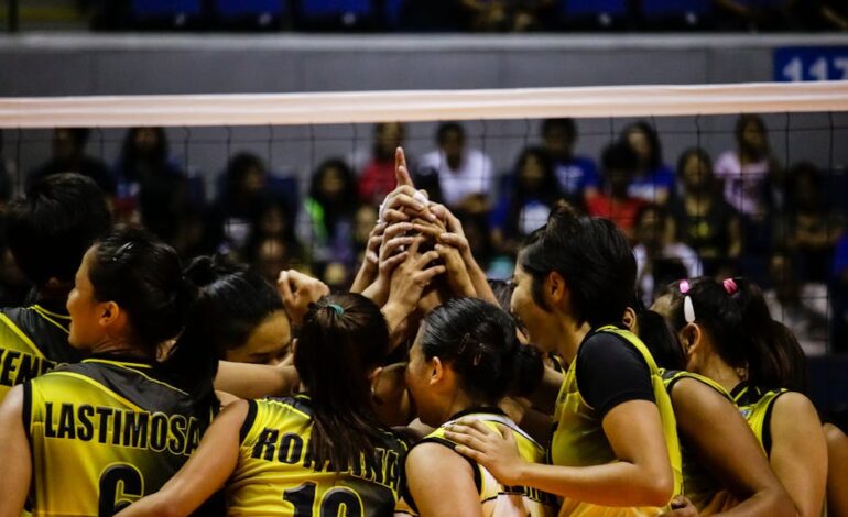 Female volleyball team huddles for a game in Quezon City, Philippines.