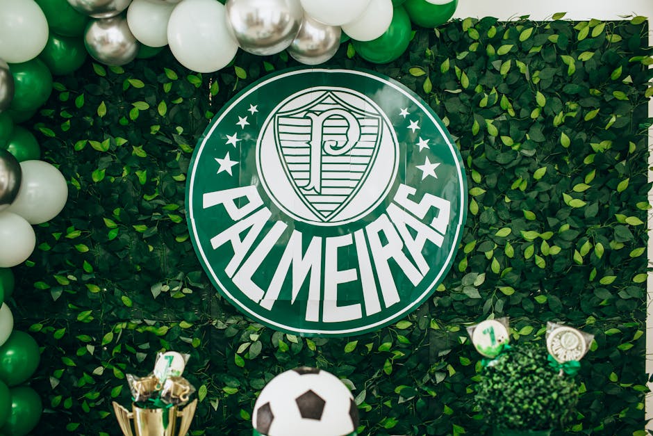 Green and white Palmeiras themed backdrop with balloons and football decorations.