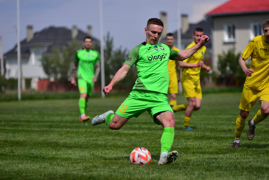 Dynamic soccer players competing in a grassy outdoor field during a sunny day.