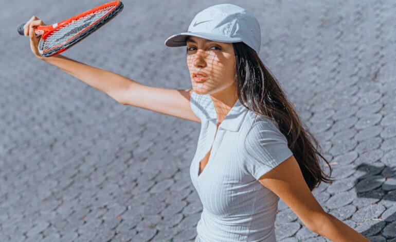 A woman holding a tennis racket while playing outdoors on a sunny day.