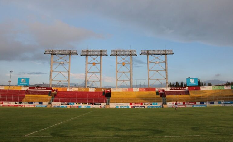 Wide view of Gonzalo Pozo Ripalda Stadium in Quito, Ecuador. Captures the peaceful atmosphere of an empty soccer field.