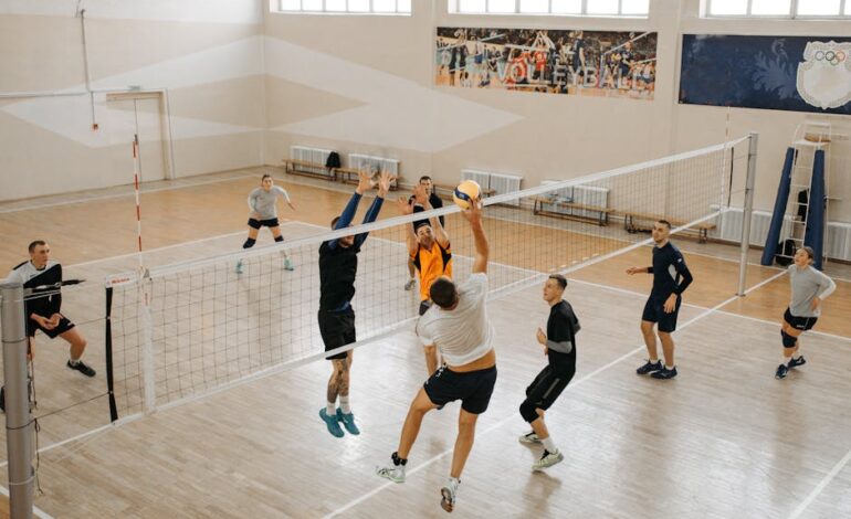 Exciting indoor volleyball game featuring diverse teams in action, jumping and playing.