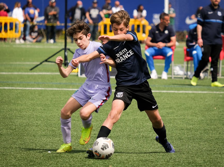 Young athletes compete in a lively soccer match in Barcellona, Italy, showcasing teamwork and sportsmanship.