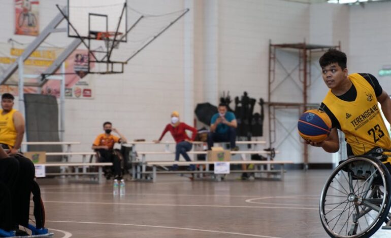 Dynamic wheelchair basketball game showcasing skill and determination indoors.