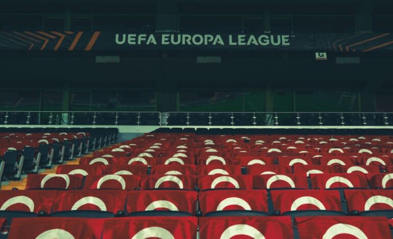 Rows of empty stadium seats adorned with UEFA Europa League banners, creating a sporting event atmosphere.