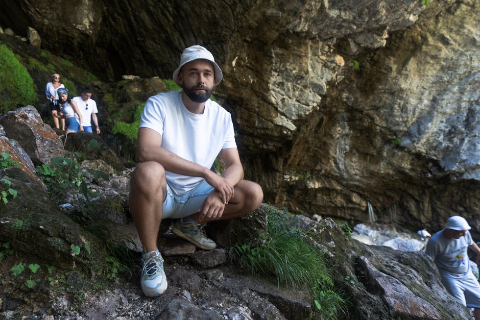 A group of hikers explore a rocky cave in Гагра, capturing the spirit of adventure.