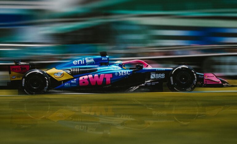 Dynamic shot of a Formula 1 car racing at Interlagos Circuit, São Paulo.