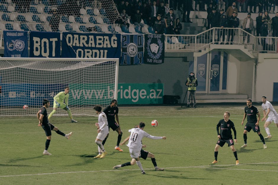 Dynamic action shot of a soccer match in Bakü, Azerbaijan, showcasing players in intense competition.