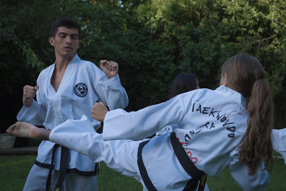 Taekwondo students practice kicks and techniques outdoors in Buenos Aires.