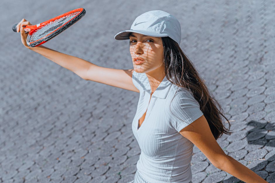 A woman holding a tennis racket while playing outdoors on a sunny day.