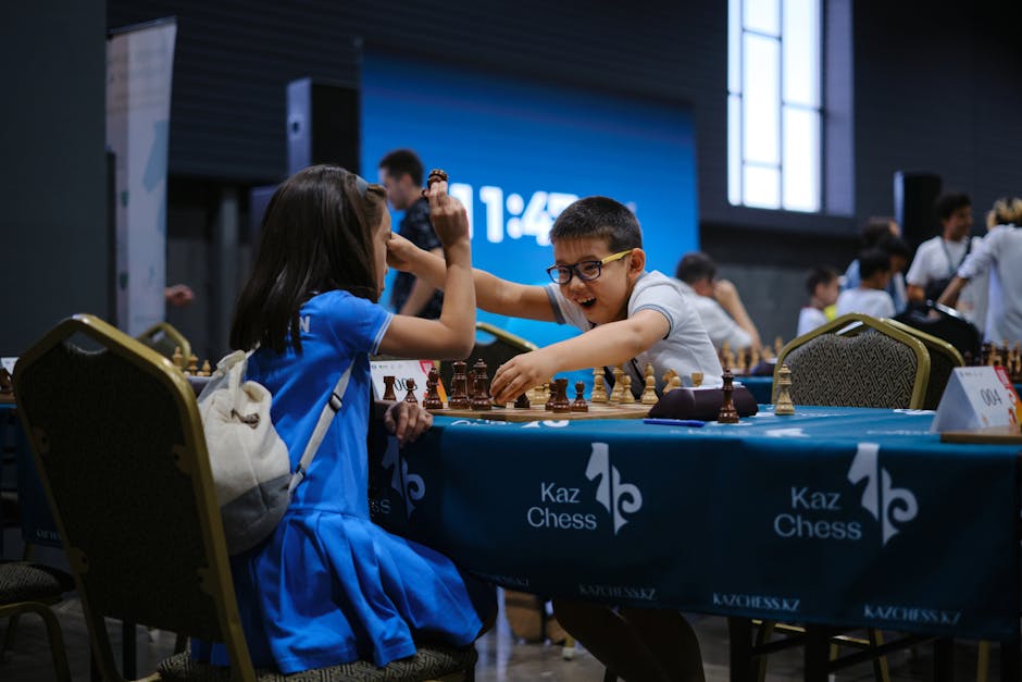 Children enthusiastically engaged in a chess game during a tournament indoors.