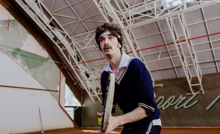 Focused tennis player poised on an indoor court, ready to serve a match-winning shot.