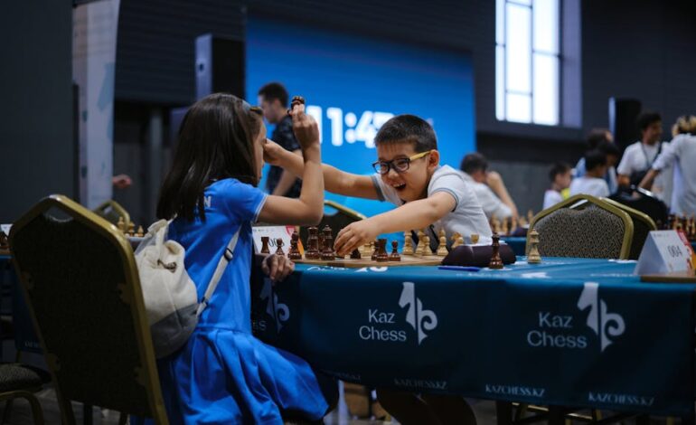 Children enthusiastically engaged in a chess game during a tournament indoors.