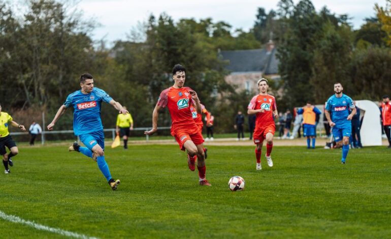 Dynamic football match action captured in France with players in red and blue jerseys.