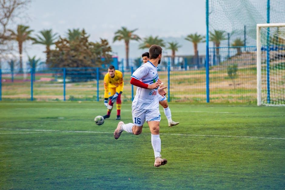 Dynamic soccer game with players in action on an outdoor field.