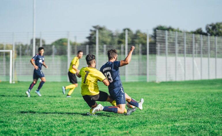 Soccer players in action during a competitive match on a sunny day outdoors.