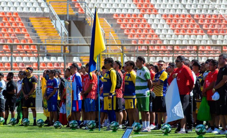 Colorful gathering of diverse soccer teams at a sunlit stadium.