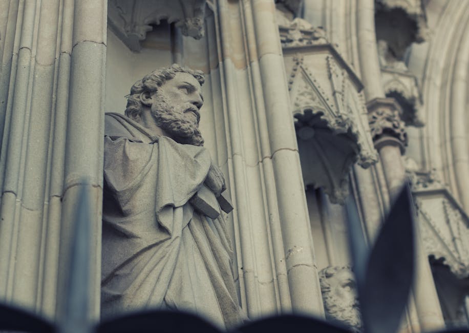 Close-up of a detailed Gothic stone sculpture in Barcelona's historic architecture.