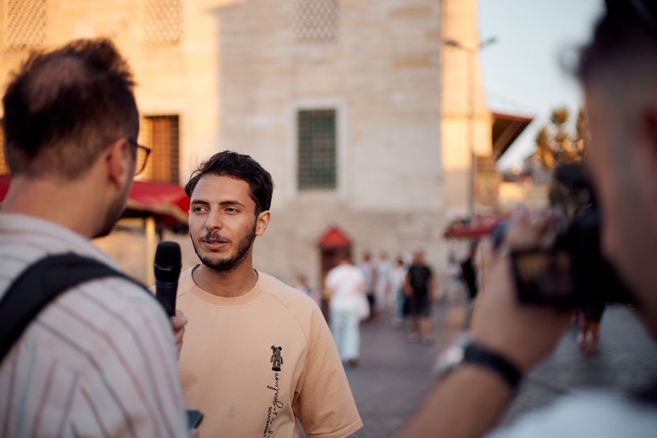 Close-up of a candid street interview scene in Istanbul during the day.