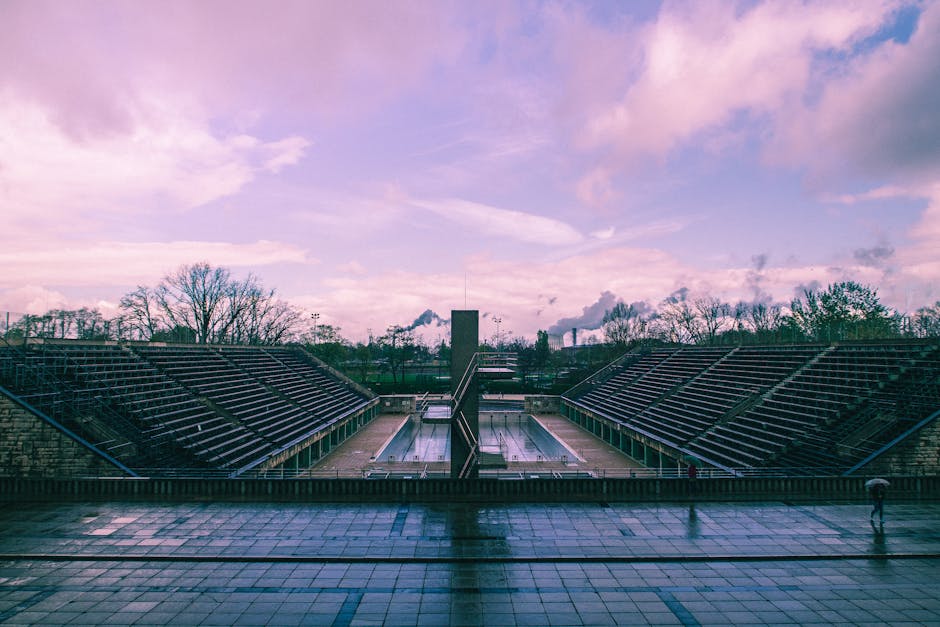 Panoramic view of Berlin's Olympic stadium outdoors with a cloudy sky.