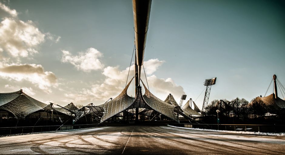 A stunning view of Munich's Olympic Park architecture under a bright sky.