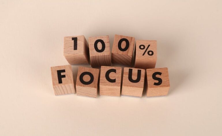 Wooden blocks arranged to spell '100% Focus', representing concentration and dedication.