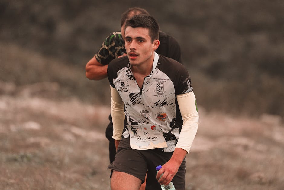 A young male athlete making an effort during an outdoor running competition.