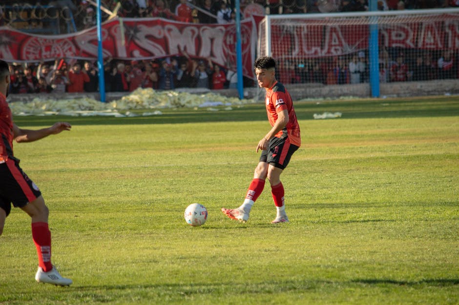 Exciting soccer match captured in Mendoza, highlighting a player's intense focus.