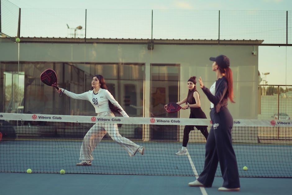 Three women enjoying a game of padel on an outdoor court at Vibora Club in Baghdad.