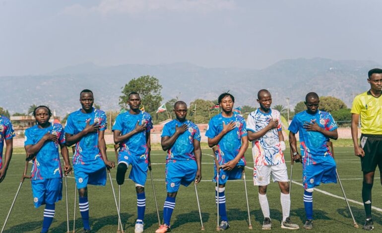 Amputee soccer team standing in unity on a sunny day on the sports field.