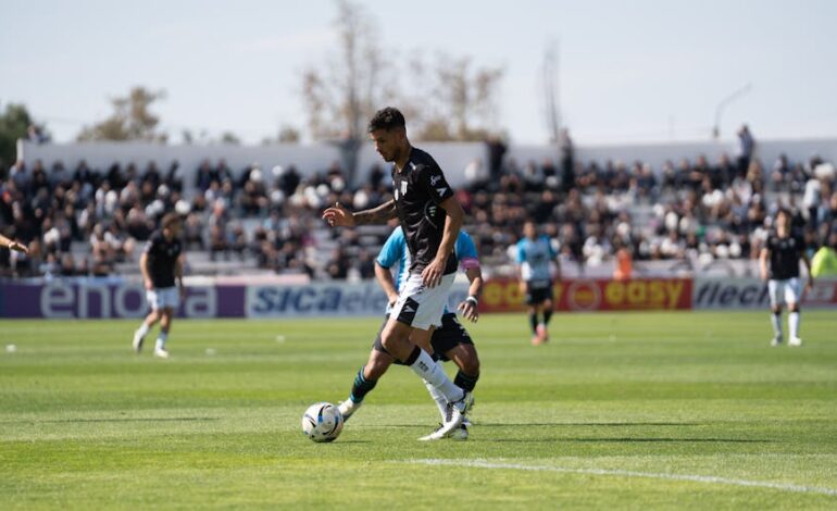 Exciting soccer game with players in action on a sunny day outdoors.