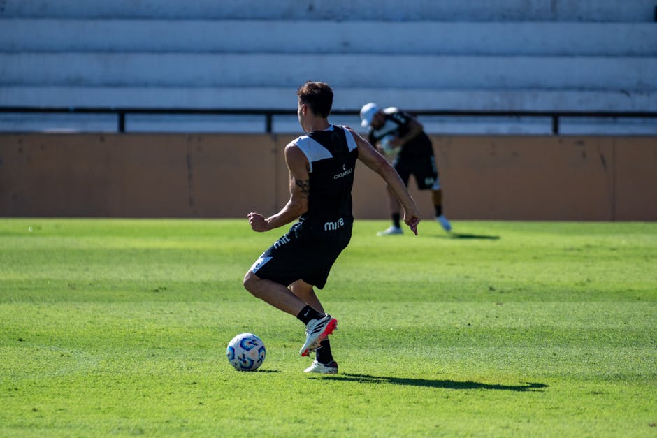 A soccer player training on a sunny day, showcasing agility and skill.