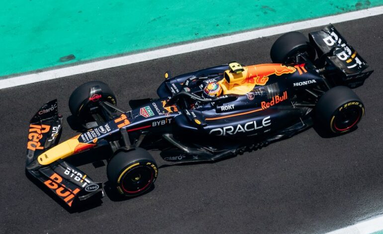 High-speed Formula 1 car on track from an aerial perspective highlighting dynamic racing action.